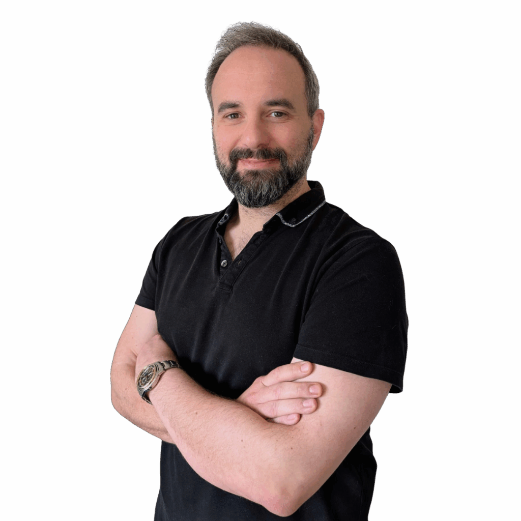 A picture of Iain stood on an angle with his arms folded